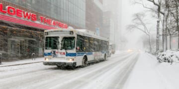 A bus drives through the winter on Broadway near 68th street in New York City during a snowfall on Feb. 9, 2017.