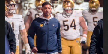 Head Coach Marcus Freeman of the Notre Dame Fighting Irish leads his team into the stadium Nov. 29 to start the second half of a college football game against the Stanford Cardinals in Palo Alto, California.