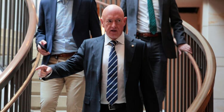 Sen. Mark Kelly arrives for a closed door meeting on Capitol Hill on Dec. 16, 2025, in Washington, D.C.