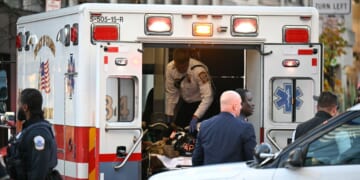 An unidentified man in military fatigues lies on a stretcher inside an ambulance on Nov. 26, 2025, in downtown Washington, D.C.