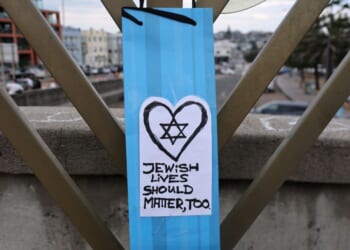 A note attached to a menorah is seen Sunday on a small bridge at Bondi Beach where gunmen stood during a mass shooting one week earlier in Sydney, Australia.