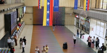 Travelers wait in the main hall of the Simon Bolivar Maiquetia International Airport in Maiquetia, Venezuela, on Nov. 23, 2025.
