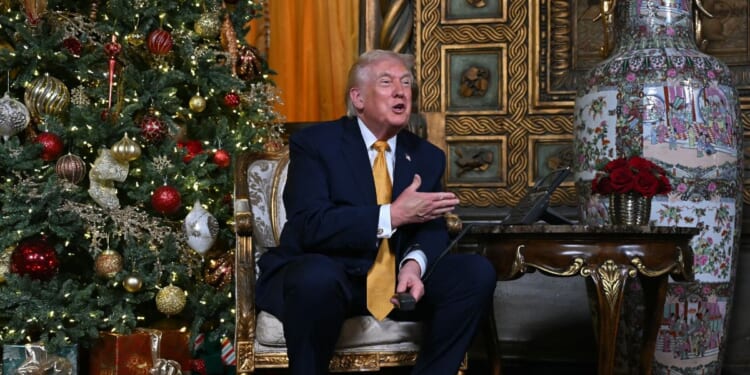 President Donald Trump answers phone calls on Christmas Eve as he participates in the NORAD Santa tracker from the Mar-a-lago club in Palm Beach, Florida, on Dec. 24, 2025.