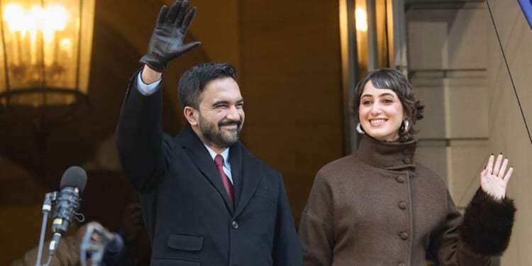 New York Mayor Zohran Mamdani and his wife Rama Duwaji wave to supporters at his ceremonial inauguration as mayor Thursday.