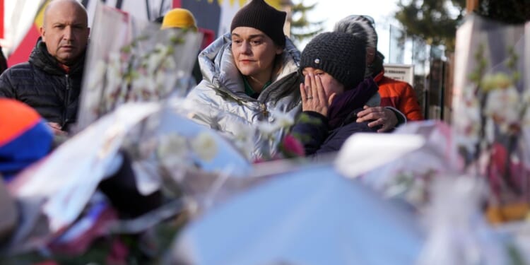 Sparkling candles atop wine bottles ignited fatal bar fire, Swiss investigators believe