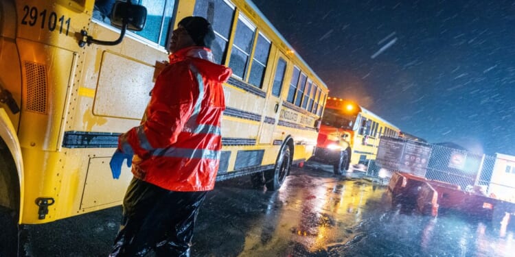 School buses drive through a storm in the Brooklyn borough of New York City on Jan. 9, 2024.