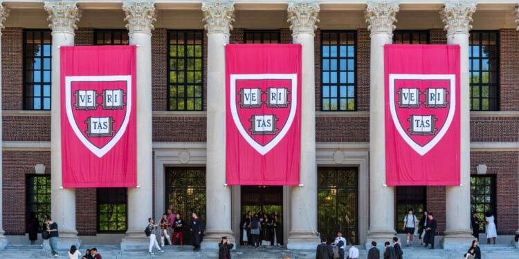 Three huge “Veritas” Banners hang from the facade of Widener Memorial Library at Harvard University.