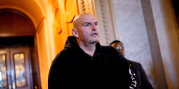 Sen. John Fetterman walks out of the Senate Chamber on Dec. 11, 2025, in Washington, D.C.