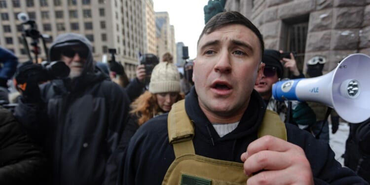 Right wing influencer Jake Lang is confronted by protesters at a rally near city hall on Jan. 17, 2026, in Minneapolis, Minnesota.