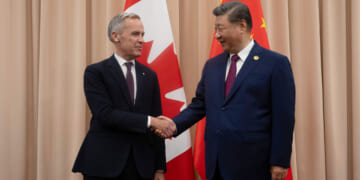 Canadian Prime Minister Mark Carney, left, greets Chinese President Xi Jinping in South Korea in a file photo from October.