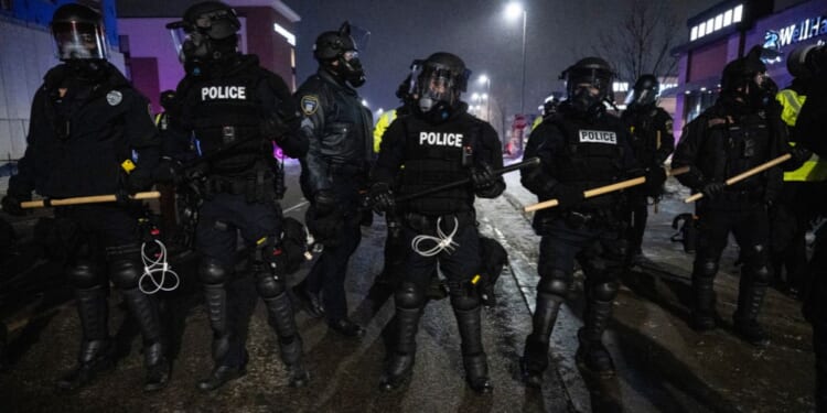 Minneapolis police form a line near so-called "protesters" and anti-ICE agitators in Maple Grove on the outskirts of Minneapolis, Minnesota, on Jan. 26, 2026.
