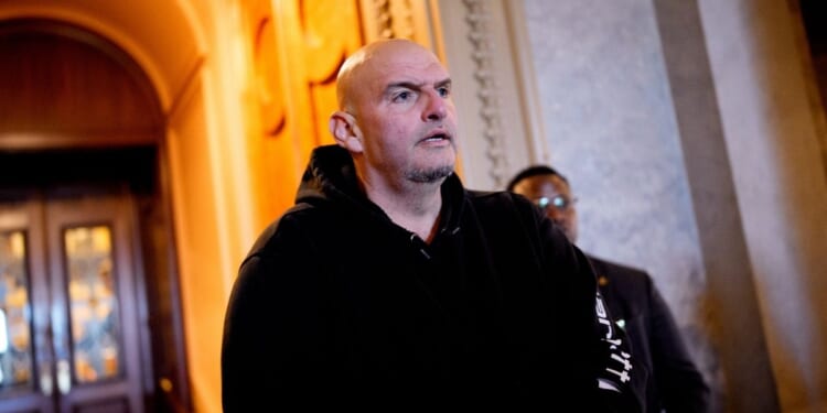 Sen. John Fetterman walks out of the Senate Chamber on Dec. 11, 2025, in Washington, D.C.