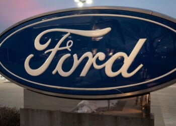 A sign with the Ford logo sits in front of a Chicago dealership in a file photo dated Dec. 15.