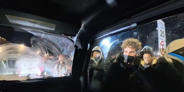 Independent journalists Nick Sortor and Cam Higby were surrounded by a mob that spray-painted their truck and smashed their windows with frozen water bottles as the two fled.