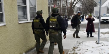 Federal agents patrol a neighborhood in St. Paul, Minnesota, on Jan. 16, 2026.