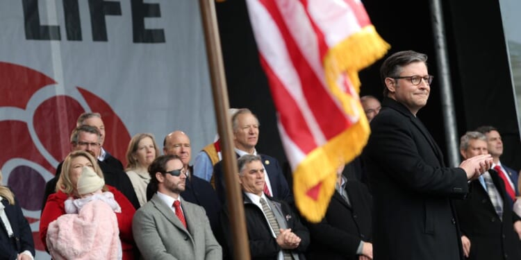 Speaker of the House Mike Johnson applauds on stage alongside fellow Republican lawmakers during the annual March for Life rally on the National Mall on Jan. 23, 2026, in Washington, D.C.