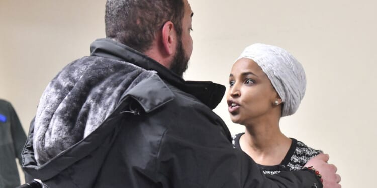 US Rep. Ilhan Omar reacts after being sprayed with an unknown substance by a man at a town hall in Minneapolis, Minnesota, on Jan. 27, 2026.