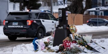 A Minneapolis police vehicle is parked near a memorial for anti-ICE protester Renee Good who was shot to death Jan. 7 while confronting Immigration and Customs Enforcement behind the wheel of her vehicle.