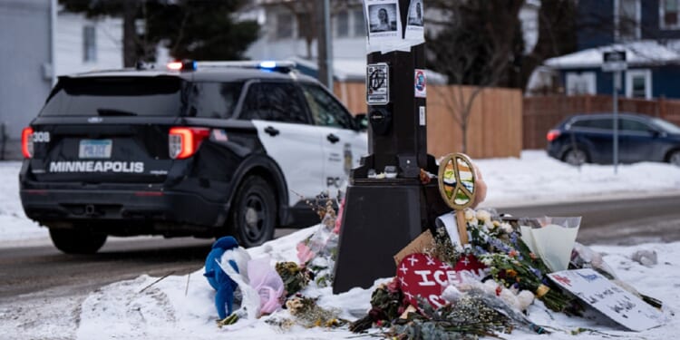 A Minneapolis police vehicle is parked near a memorial for anti-ICE protester Renee Good who was shot to death Jan. 7 while confronting Immigration and Customs Enforcement behind the wheel of her vehicle.
