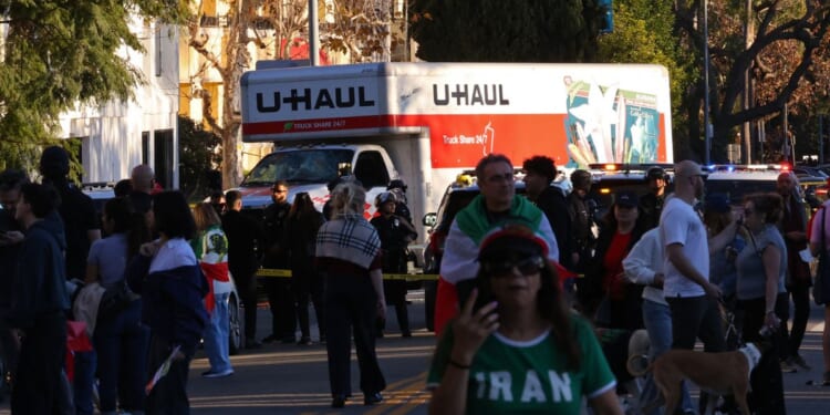 People walk near a U-Haul truck that reportedly was driven into a crowd during an anti-Iranian regime rally on Jan. 11, 2026, in Los Angeles, California.