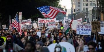 People wave flags and hold signs during a protest in Los Angeles, California, on Jan. 10, 2026, against U.S. Immigration and Customs Enforcement after the fatal shooting of Renee Nicole Good in Minneapolis, Minnesota.