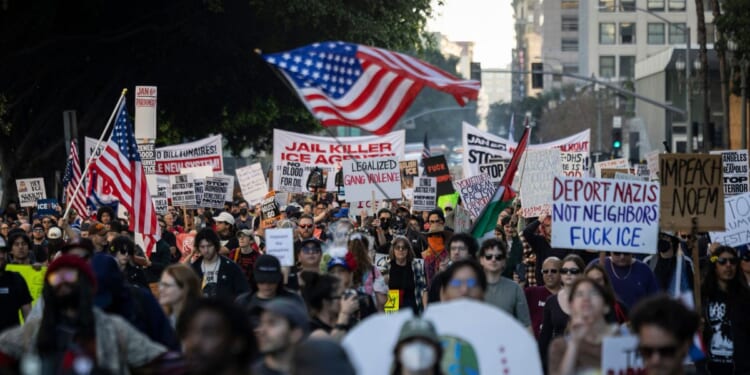 People wave flags and hold signs during a protest in Los Angeles, California, on Jan. 10, 2026, against U.S. Immigration and Customs Enforcement after the fatal shooting of Renee Nicole Good in Minneapolis, Minnesota.