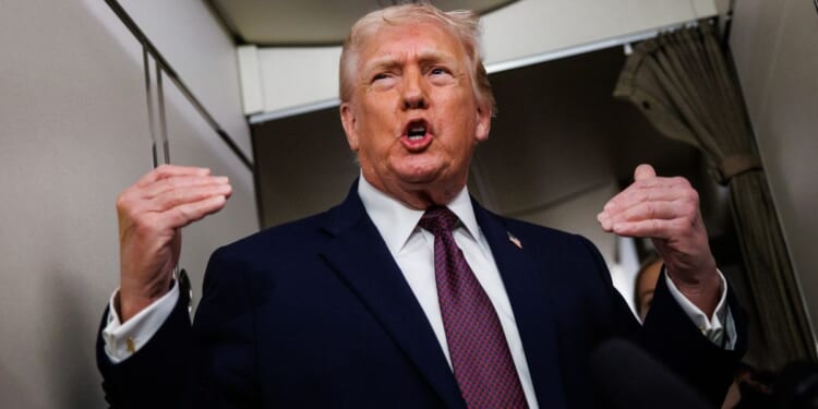 President Donald Trump takes questions from the members of the media aboard Air Force One Sunday en route back to the White House from Palm Beach, Florida.