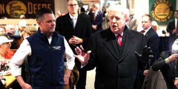 President Donald Trump speaks to guests alongside GOP Rep. Zach Nunn of Iowa, left, as he visits the Machine Shed restaurant Tuesday in Urbandale, Iowa.