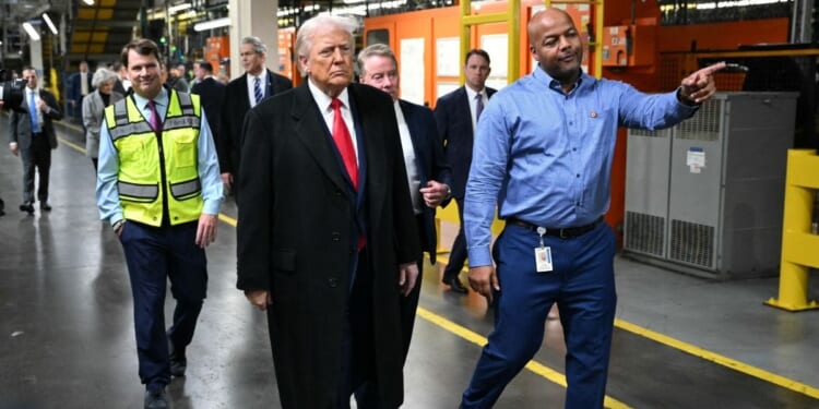 President Donald Trump, alongside Ford CEO Jim Farley, Treasury Secretary Scott Bessent, Ford executive chairman Bill Ford, and plant manager Corey Williams, tours Ford Motor Company's River Rouge complex in Dearborn, Michigan, on Jan. 13, 2026.