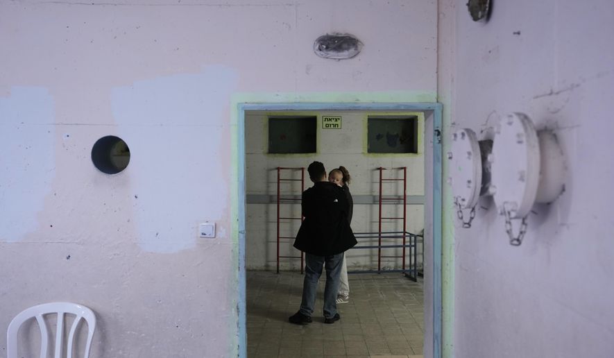 Civilians staying in a shelter after alarms announced that Israel had launched an attack on Iran, in Ramat Gan, Israel, Saturday, Feb. 28, 2026. (AP Photo/Oded Balilty)