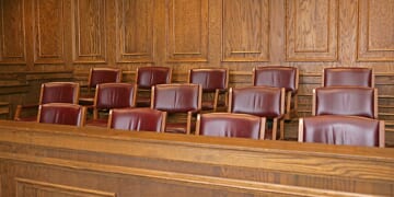A jury box sits in a courthouse's courtroom.