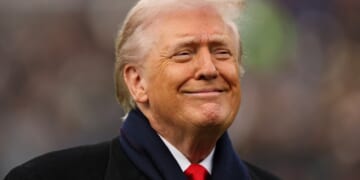 President Donald Trump grins in a file photo from the Dec. 13, Army-Navy Game in Baltimore.