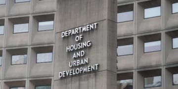 A view of the U.S. Department of Housing and Urban Development from the outside with the department's name displayed on the side of the building.