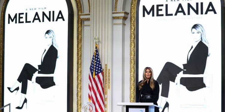 First lady Melania Trump, flanked by posters for "Melania," the documentary about her, delivers remarks before ringing the opening bell at the New York Stock Exchange in New York on Wednesday.