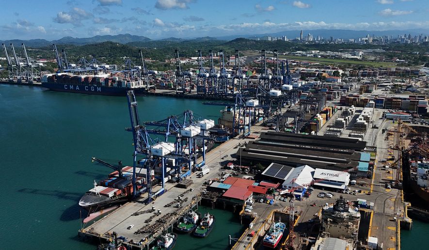 Cranes load a cargo ship at Panama Canal's Port of Balboa, managed by CK Hutchison Holdings, in Panama City, Friday, Jan. 30, 2026. (AP Photo/Matias Delacroix)