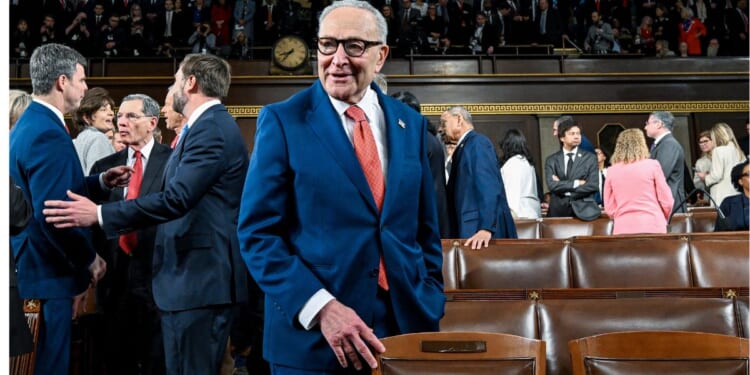 Senate Minority Leader Chuck Schumer, a New York Democrat, chats with colleagues before President Donald Trump's State of the Union address Tuesday at the Capitol in Washington, D.C.
