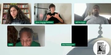 A sign language interpreter, top center, appeared surprised at the passage read during the meeting of a Chicago-area Muslim group.