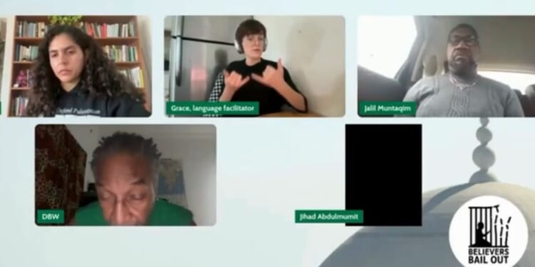 A sign language interpreter, top center, appeared surprised at the passage read during the meeting of a Chicago-area Muslim group.