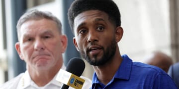 Baltimore Mayor Brandon Scott speaks as Acting Baltimore Police Commissioner Richard Worley listens during a news conference at the police headquarters on July 3, 2023, in Baltimore, Maryland.