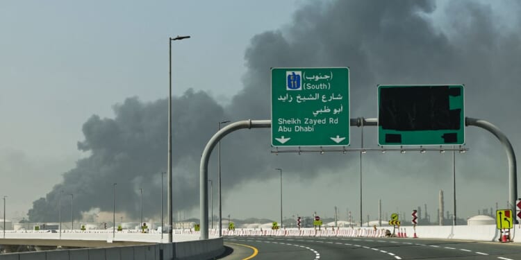 A plume of smoke rises from the port of Jebel Ali Sunday following an Iranian strike in Dubai, United Arab Emirates. News outlets reported Tuesday that a new strike targeted the U.S. consulate compound in the city.