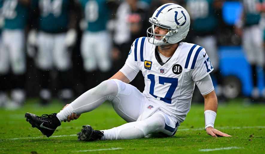 Indianapolis Colts quarterback Daniel Jones (17) grabs his leg after an injury during the first half of an NFL football game against the Jacksonville Jaguars, Sunday, Dec. 7, 2025, in Jacksonville, Fla. (AP Photo/Phelan M. Ebenhack)