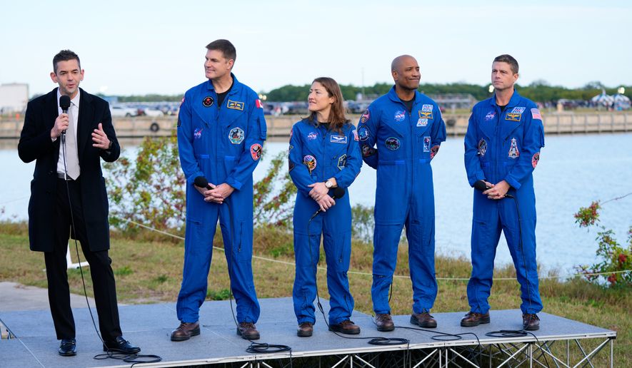 FILE - NASA administrator Jared Isaacman, left, answers questions during a news conference, next to the crew of the new moon rocket, Artemis II, from left, Canadian Space Agency astronaut Jeremy Hansen, mission specialist Christina Koch, pilot Victor Glover and commander Reid Wiseman at the Kennedy Space Center, Jan. 17, 2026, in Cape Canaveral, Fla. (AP Photo/John Raoux, FIle)