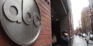 People walk by the ABC Headquarters in Atlanta, Georgia, on Feb. 24, 2010