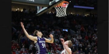 High Point guard Chase Johnston (99) watches his 2-point shot go in the basket during the final seconds of the second half in the first round of the NCAA college basketball tournament against Wisconsin, Thursday in Portland, Ore. The shot put High Point ahead of Wisconsin.