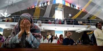 Christian attendees of a church in Islamabad pray on April 20, 2025.