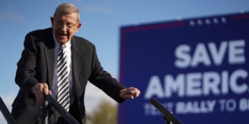 Lou Holtz leaves the stage during a rally with President Donald Trump at the Florence Regional Airport on March 12, 2022, in Florence, South Carolina.