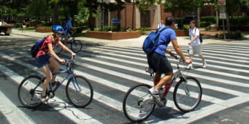 University of Florida students make their way through a crosswalk near the campus landmark Century Tower in Gainesville, Florida.