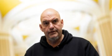 Sen. John Fetterman speaks to reporters as he leaves the Senate Chamber at the U.S. Capitol on Jan. 29, 2026, in Washington, D.C.