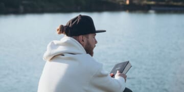 A Christian man holds a Bible in his hands.