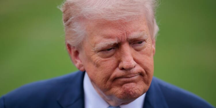 President Donald Trump stops to speak with reporters outside the White House on March 20, 2026, in Washington, DC.